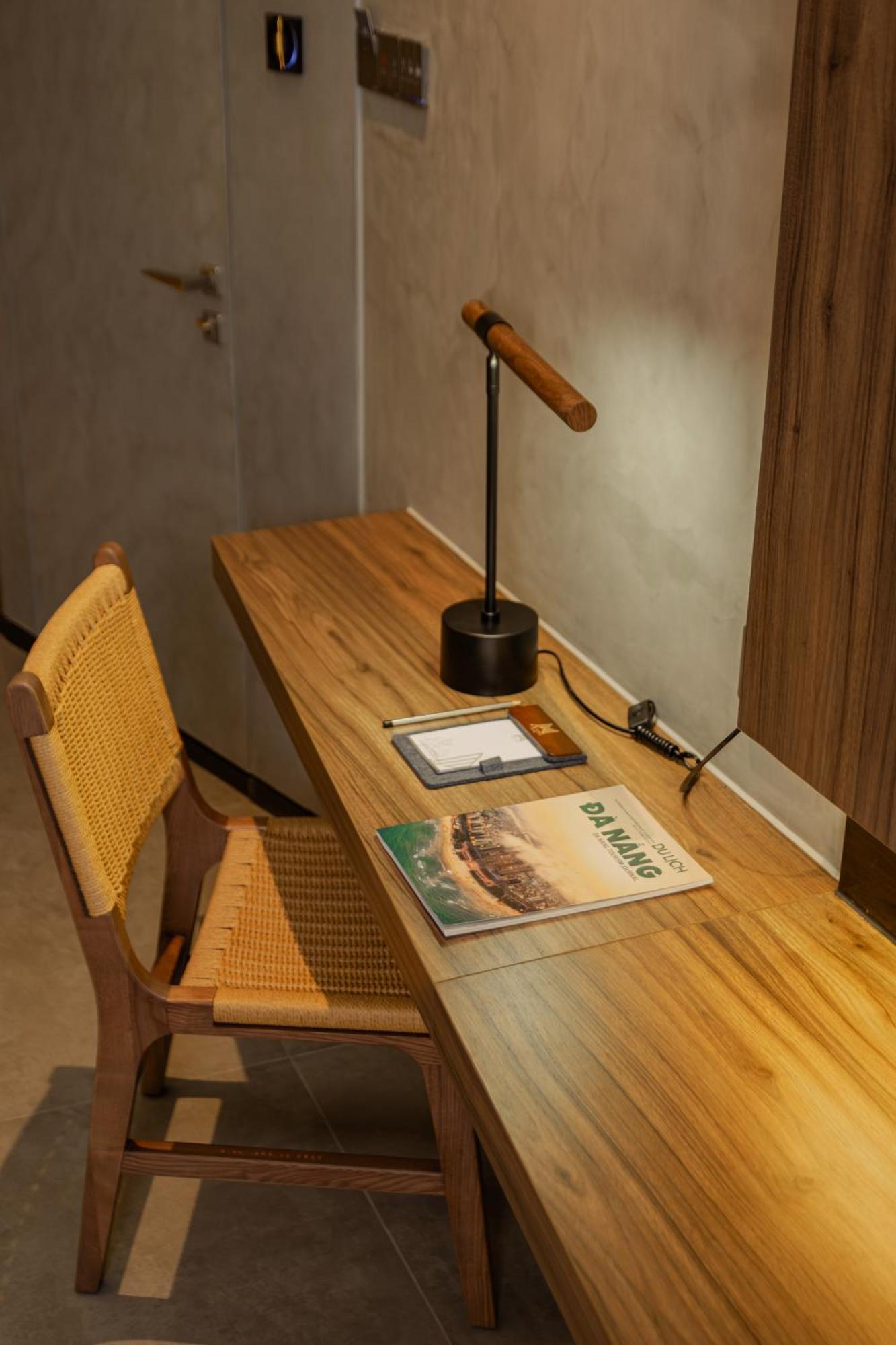 M Hotel Danang Exteriér fotografie A desk with a magazine on it